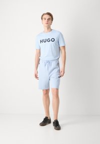 BOSS HEADLO - Spodnji deli trenirk - light blue