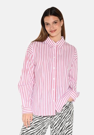 White button-up shirt with red vertical stripes, featuring a collar and long sleeves, paired with zebra-striped pants. Smooth cotton texture.