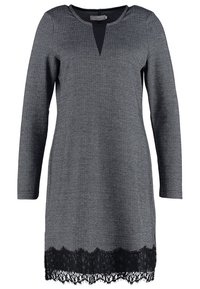 Szara sukienka z długimi rękawami i dekoltem w serek. Posiada teksturowany wzór w rybią łuskę oraz czarną koronkę na dole.