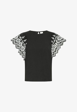 Must värviga särk, millel on valged pitsist kätised ja lilleline tikand. Ümar kaelus ja taga nööbid, et hõlbustada selga panemist.