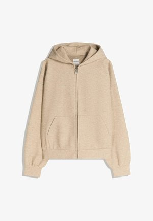 Beige zip-up huppari, jossa on pehmeä, teksturoitu pinta, kengurulaukut edessä ja huppu, jossa on naru.