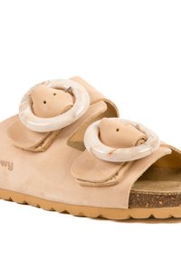 Sandales en suède beige avec deux boucles rondes marbrées surdimensionnées, des sangles réglables et une semelle intérieure en liège texturé. Semelle en caoutchouc pour une meilleure adhérence.