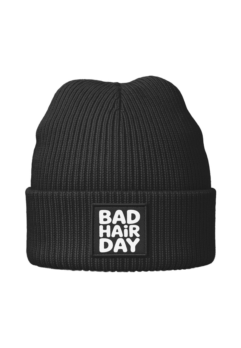 Black knit beanie with ribbed texture, featuring a folded cuff and a square patch displaying the text "BAD HAIR DAY" in bold white letters.
