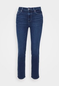 Jean bleu foncé droit avec poches avant, passants de ceinture, fermeture par bouton et légère décoloration au niveau de la cuisse supérieure.