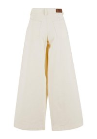 Cream-colored wide-leg trousers made of soft fabric, featuring two back pockets and a smooth waistband with a brown leather label.