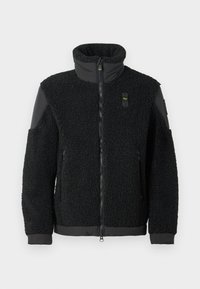 Czarna kurtka polarowa z wysokim kołnierzem, zapięciem na zamek oraz kontrastującymi czarnymi wstawkami na ramionach i mankietach. Charakteryzuje się fakturowaną, miękką powierzchnią.