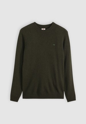 Pull vert foncé en maille lisse, avec un col rond et des poignets et un ourlet côtelés. Petit logo sur la poitrine.