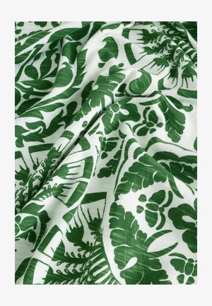 Green and white patterned fabric featuring leafy designs. Soft texture with a smooth finish, displaying intricate botanical motifs.