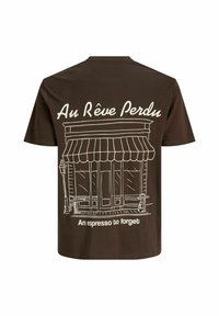 Brown t-shirt featuring a white illustrated café front, text "Au Rêve Perdu" and "An espresso to forget." Round neck, short sleeves.