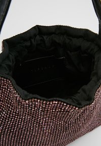 Black fabric handbag with metallic rose-colored embellishments, featuring a soft, gathered opening and smooth interior lining.