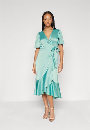 A teal satin wrap dress with short puff sleeves, a fitted waist, and a ruffled skirt hem. The dress features a tie detail at the waist.
