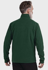 Grüne Fleecejacke mit hohem Kragen und langen Ärmeln, mit glatter Textur und geradem Saum. Keine sichtbaren Beschläge oder Muster.