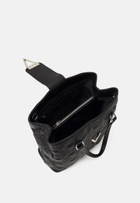 Black quilted handbag with a smooth interior, zipper pocket, and a structured design. Features metallic hardware and adjustable straps.