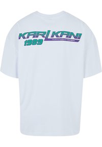 Balta medvilninė marškinė su trumpomis rankovėmis, ant nugaros su retro grafiku purpurine ir žydra spalvomis, užrašytu "KARL KANI 1989".