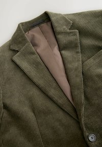 Blazer de pana en verde oliva con solapa de muesca, botón visible y forro interior liso en marrón, colocado sobre un fondo blanco.