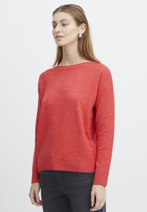 Pull rouge avec une coupe légèrement décontractée, un col rond et des poignets côtelés. Fabriqué à partir d'un matériau texturé, avec une légère variation de teinte.