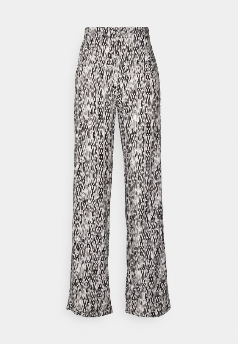 Zwart-wit gestreepte broek met brede pijpen en een elastische taille. Heeft een gestructureerde stof met een verticale zigzagpatroon.