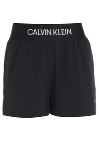 Black Calvin Klein athletic shorts with elastic waistband featuring white brand logo text.