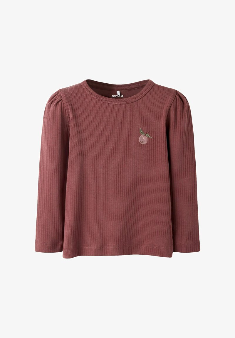 Långärmad, ribbad topp i dämpad rosafärg med rund hals och samlade axlar, med en liten broderad fruktdesign på bröstet.