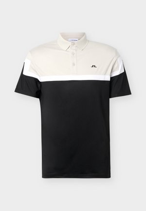 Kurzärmeliges Poloshirt mit beigem Oberteil, weißem Streifen, schwarzem Unterteil, drei Knöpfen, Kragen und kleinem schwarzem Logo auf der Brust.