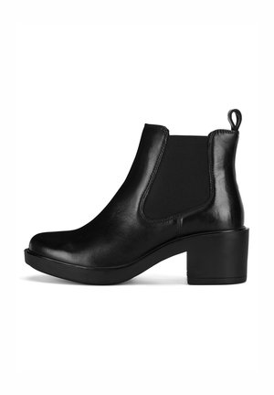 Juoda odinė kulkšnies aulinė su lygiu paviršiumi, elastingomis šoninėmis įsiuvomis ir apvaliu pirštu. Pasižymi masyviu juodu kulnu ir užtraukiamu kilpeliu gale.