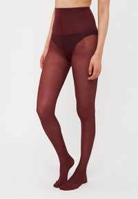 Collant bordeaux a vita alta, texture trasparente, finitura liscia, design con piedi e una fascia opaca e spessa per supporto e comfort.