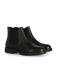 Botas Chelsea de cuero negro con paneles elásticos en los costados y una suela de goma texturizada, diseñadas con un acabado suave y una construcción robusta.