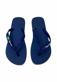 Infradito blu navy con soletta texturizzata e cinturini in gomma. Presentano una piccola bandiera brasiliana e il logo "Ipanema" sul cinturino.