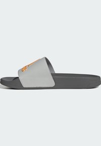 Slide sandal featuring a grey textured strap with orange logo detail, and a solid grey footbed with a low-profile design.