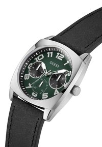 Orologio con cassa argentata e quadrante verde, grandi numeri bianchi, tre quadranti neri e cinturino in pelle nera.