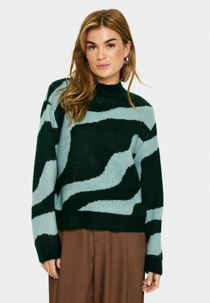 Pull en tricot avec des motifs ondulés verts et bleu clair, col montant et coupe décontractée. Le matériau semble doux avec des poignets et un ourlet côtelés.