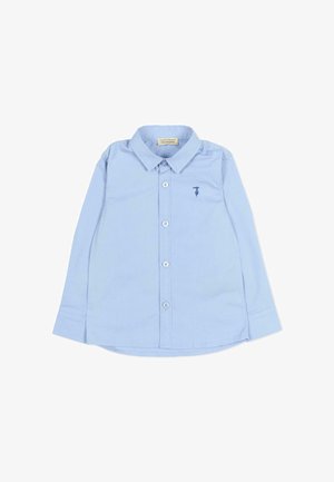 Chemise bleu clair à manches longues avec boutons, col et petit logo brodé sur la poitrine gauche, posée à plat sur fond blanc.