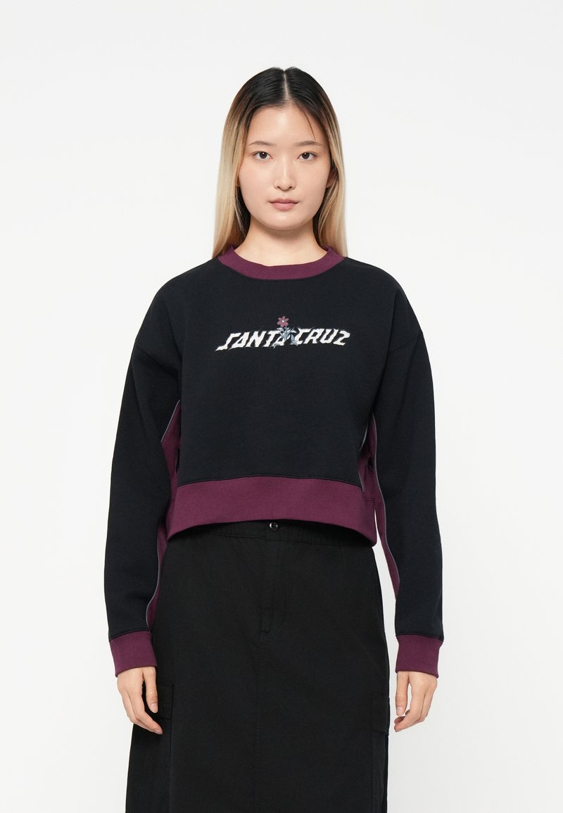 Svart kort sweatshirt med maroon detaljer, med "SANTA CRUZ" logo i en fet font. Designet har rund hals og lange ermer.