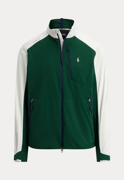 Veste softshell zippée verte et blanche avec col montant, poches poitrine et latérales zippées, et logo Polo Ralph Lauren sur le côté gauche de la poitrine.