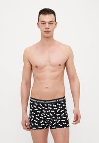 Boxer neri con motivo di occhiali da sole bianchi, dotati di una vita elastica contrassegnata da "KARL LAGERFELD", realizzati in un tessuto morbido e elasticizzato.