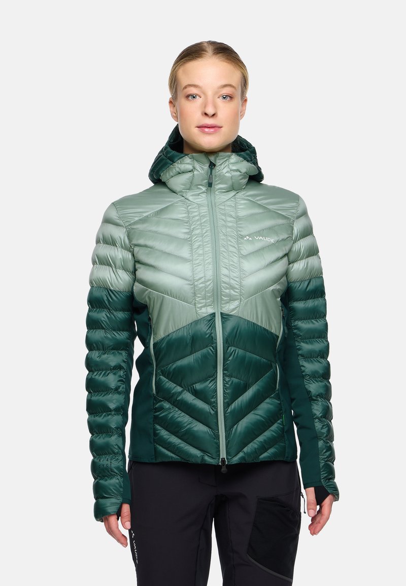 Gewatteerde jas met capuchon in lichtgroen en donkergroen. Bevat een chevrondesign, een ritssluiting aan de voorkant en elastische manchetten. Glad, glanzend materiaal.