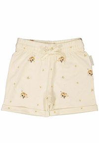 Krämfärgade shorts med elastisk midja och dragsnöre. Har ett tryckt mönster av djurhuvuden och små gula blommor.