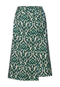Kjol i krämfärgad med grön ikatmönster. Har hög midja och asymmetrisk fåll. Tillverkad av lätt, strukturerad tyg.