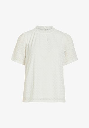 Valge lühikeste varrukatega pluus tekstuurse ümmarguse mustriga, kõrge volangikaelusega ja tagant nööbitav.