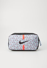Nike pouch in lightweight fabric featuring a geometric pattern in blue, red, and black, with a prominent black logo and zip closure.
