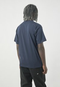 Navy blue short-sleeve t-shirt with a relaxed fit, made of soft cotton, featuring a smooth texture and no visible patterns or accents.