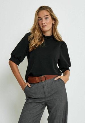 Black short-sleeve top with a high neck, paired with gray wide-leg trousers and a brown belt featuring a circular buckle.