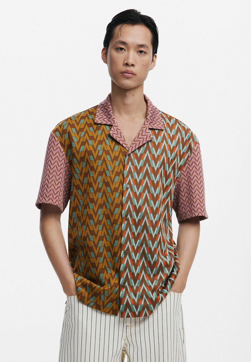 Short-sleeve shirt featuring a geometric zigzag pattern in brown, aqua, and pink. Collared design with a button front and relaxed fit.