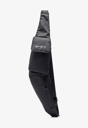 Schwarze Crossbody Sling Bag mit Frontklappentasche der Marke "yourturn" und Reißverschlussfach darunter, verstellbarer Riemen sichtbar.