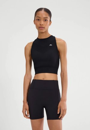 Top corto deportivo negro con escote alto y patrón de chevron texturizado, combinado con shorts negros de talle alto, ambos hechos de material ajustado.