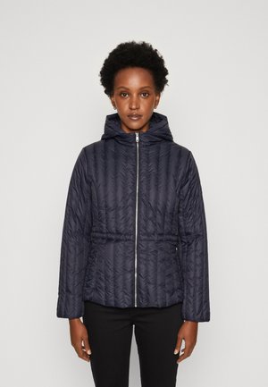 Navy puffer jacket with a hood, front zipper, quilted texture, and elastic waist. Long sleeves and minimalistic design.