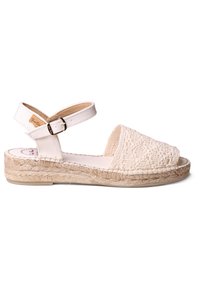 Light beige espadrille sandal with woven fabric upper, ankle strap with buckle, and jute-wrapped sole. Open toe and flat heel design.