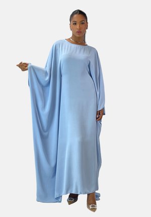 Light blue, long-sleeved maxi dress with wide sleeves and a round neckline. Smooth fabric texture, ankle-length, paired with pointed toe heels.