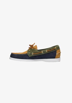 Men’s multicolor leather boat shoe with blue, green, and tan panels, white sole, and leather lace tied on top.