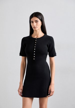 Black ribbed dress with short sleeves, featuring a crew neckline and a row of metallic buttons down the front. Smooth texture, fitted shape.